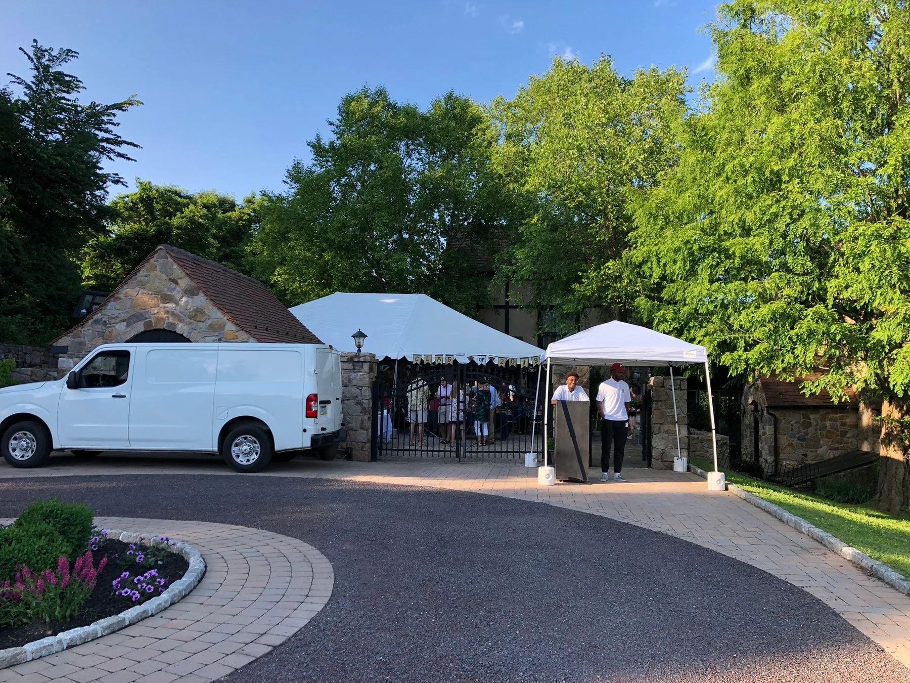 Valet attendants and a stand at a private event entrance